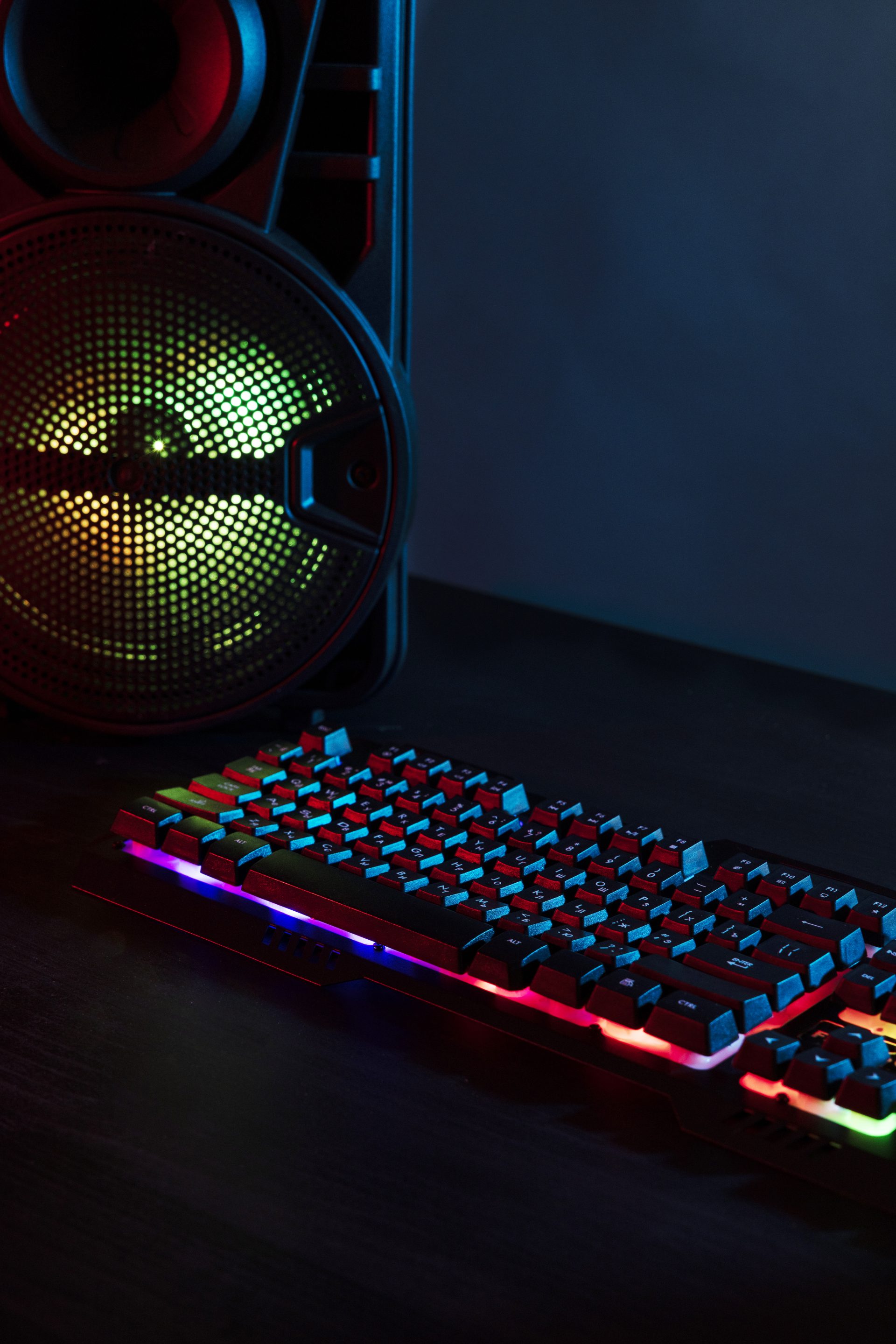 View Of Neon Illuminated Gaming Desk Setup With Keyboard